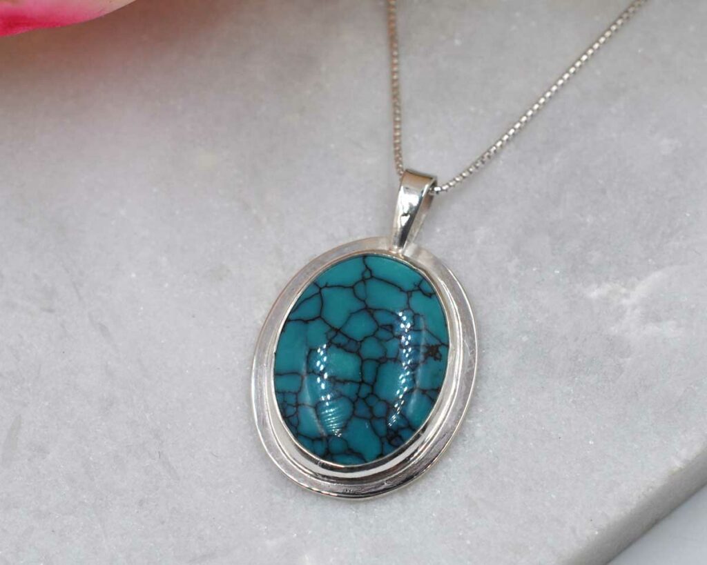 N3127-Hubei-Oval-Turquoise-and-sterling-silver-necklace-flatlay-2-angled